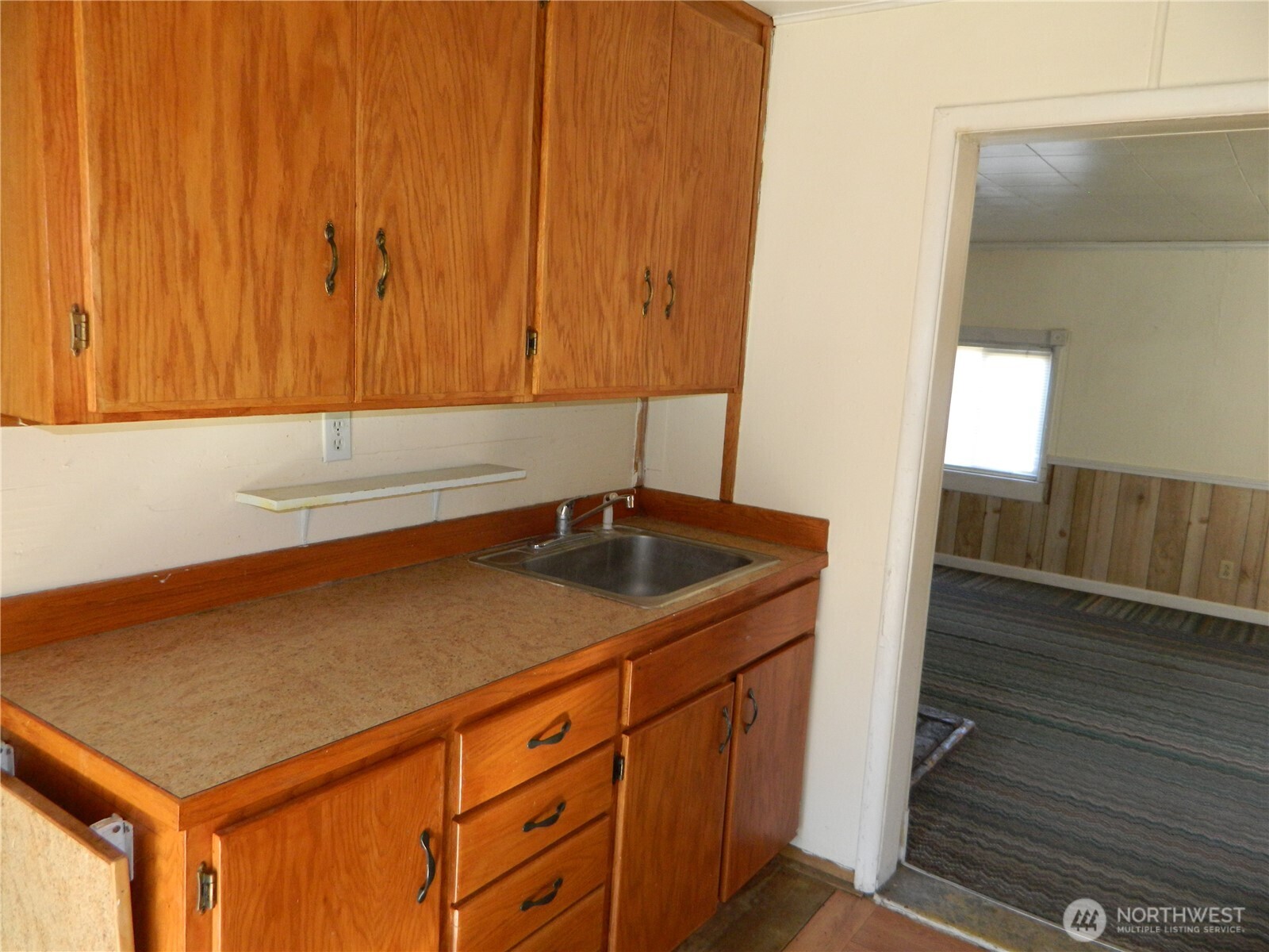 2127 Sinlahekin Road Loomis, WA 98827 - Photo 12 of 16 a kitchen with a sink and cabinets