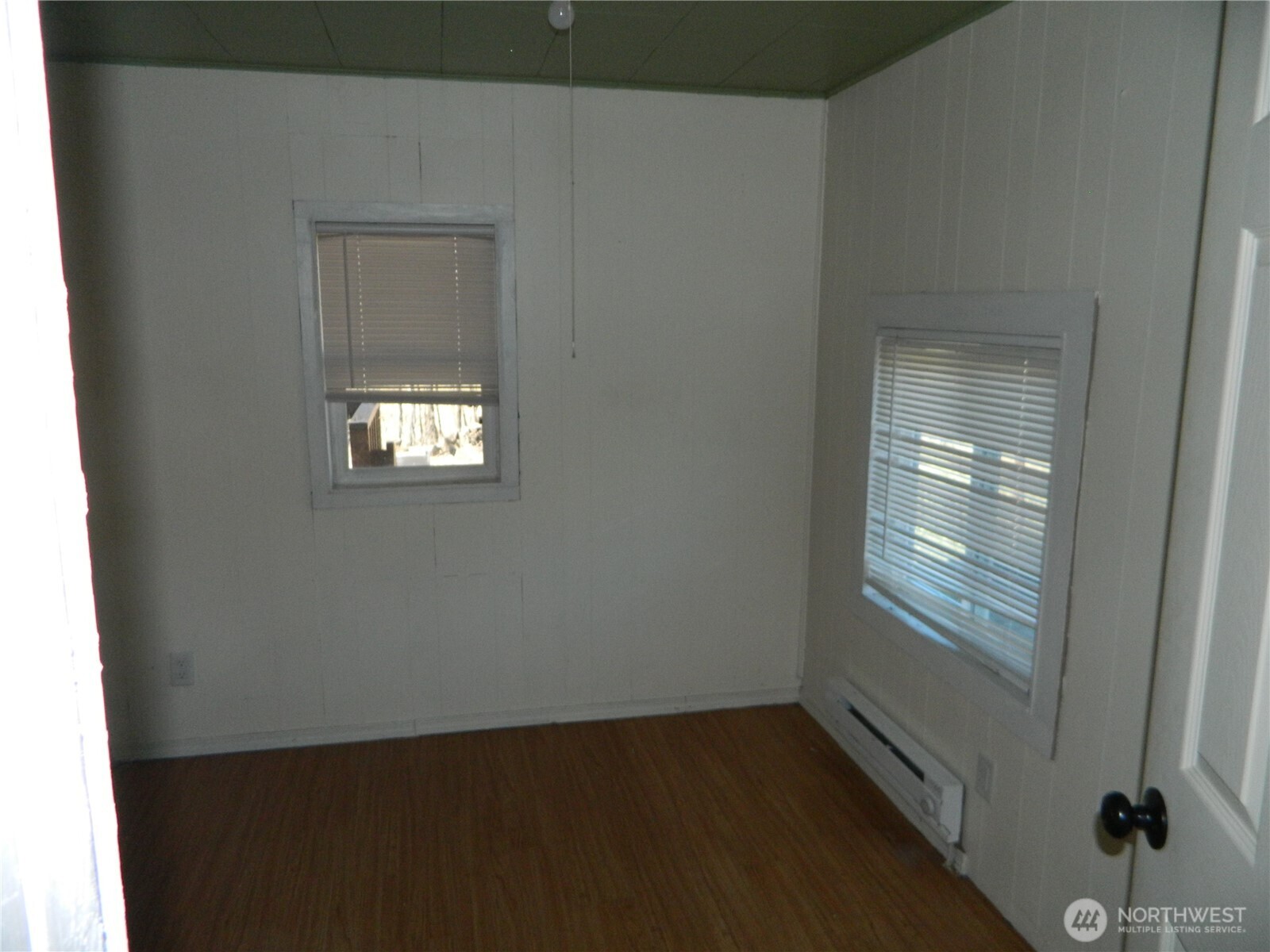 2127 Sinlahekin Road Loomis, WA 98827 - Photo 19 of 24 a view of an empty room with wooden floor and a window