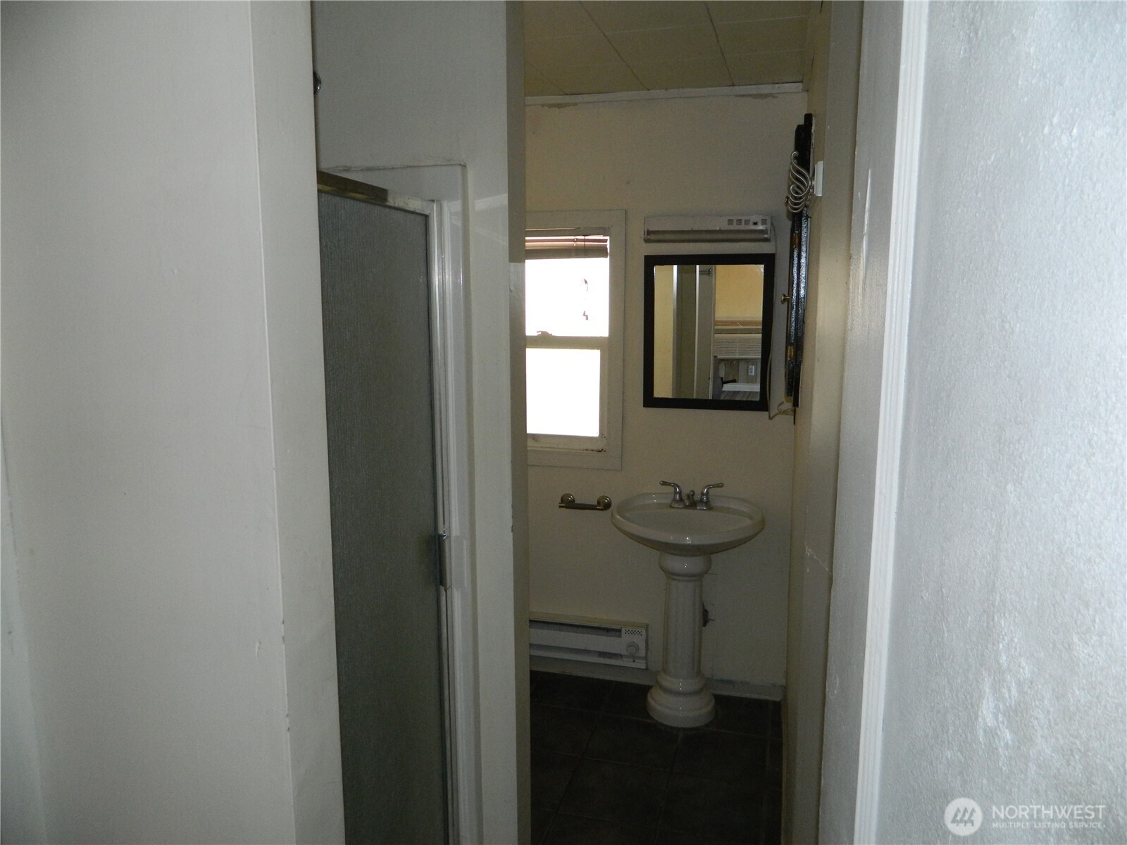 2127 Sinlahekin Road Loomis, WA 98827 - Photo 20 of 24 a bathroom with a sink and mirror
