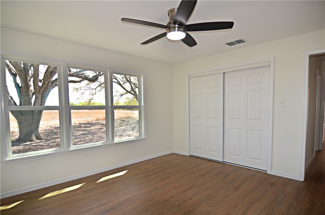 202 Ranch Road Mathis, TX 78368 - Photo 15 of 36 a view of an empty room with wooden floor and a window