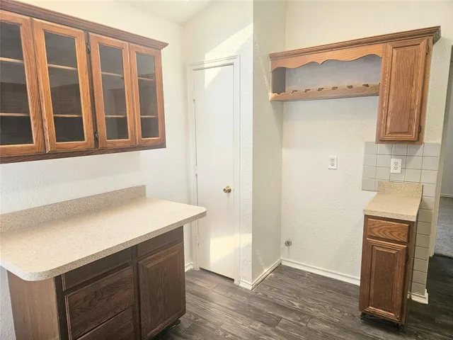 a kitchen with a sink cabinets and wooden floor