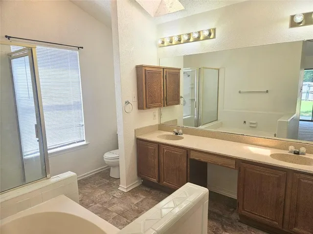 a spacious bathroom with a bathtub sink and a toilet