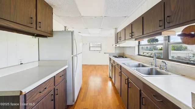 a kitchen with a sink stove and cabinets