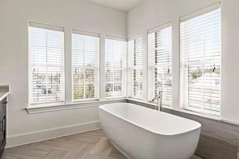 a large bathroom with double vanity and a large mirror