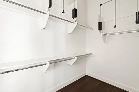 a view of walk in closet with white walls