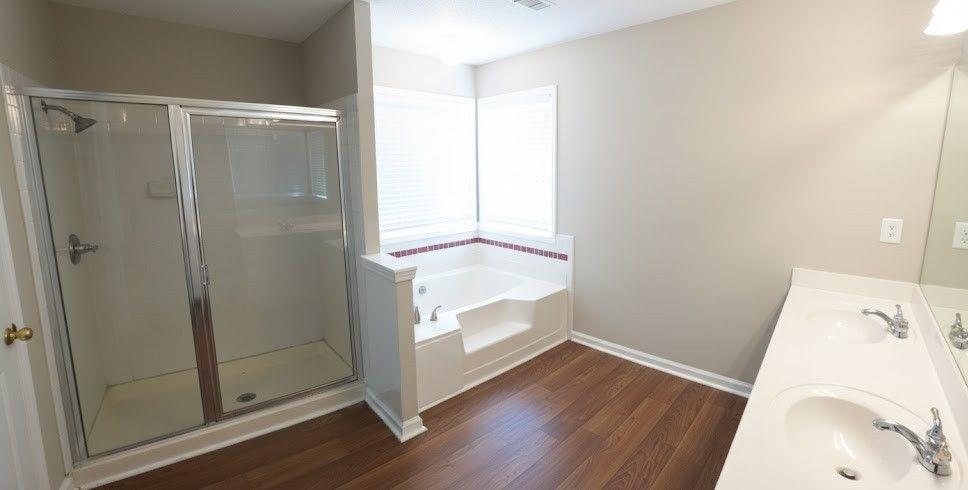 984 Pointers Way Lawrenceville, GA 30043 - Photo 17 of 20 a bathroom with a bathtub and shower