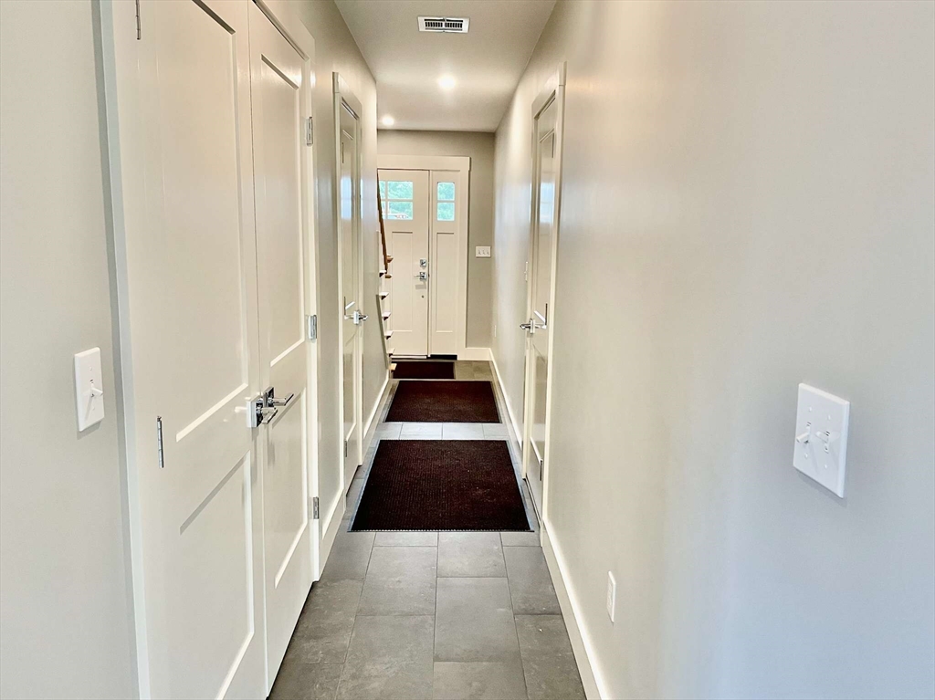 75 Neponset Street, Unit 5 Canton, MA 02021 - Photo 17 of 27 a view of a hallway with a wooden floor