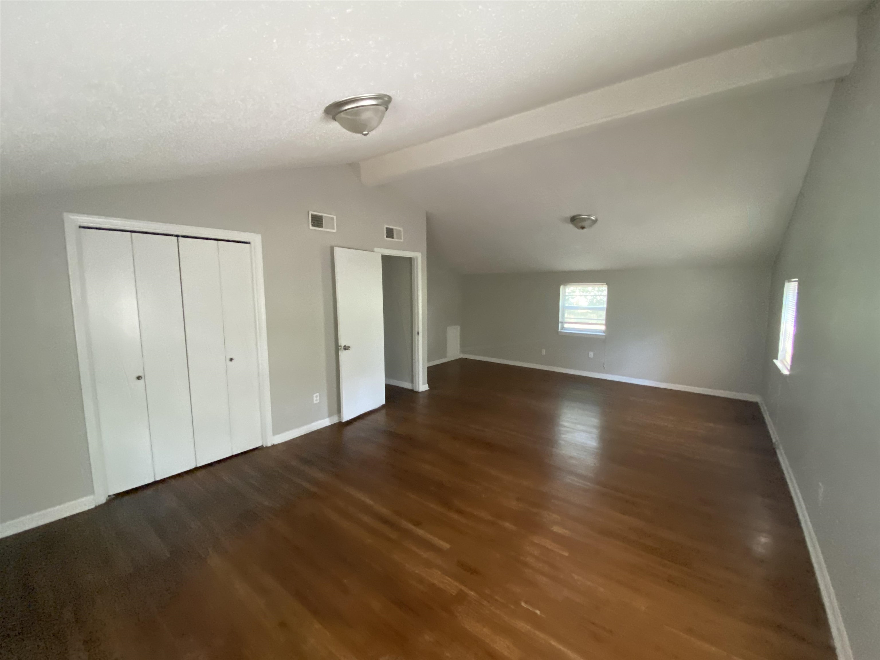 5462 Haleville Road Memphis, TN 38116 - Photo 6 of 7 a view of empty room with window and wooden floor