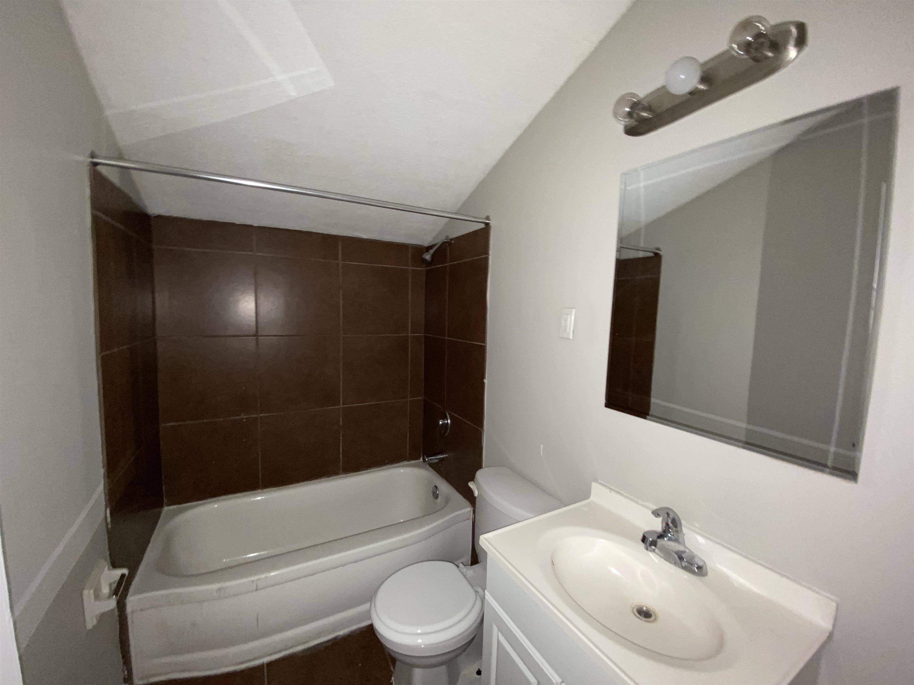 5462 Haleville Road Memphis, TN 38116 - Photo 7 of 7 a bathroom with a toilet a sink and bathtub
