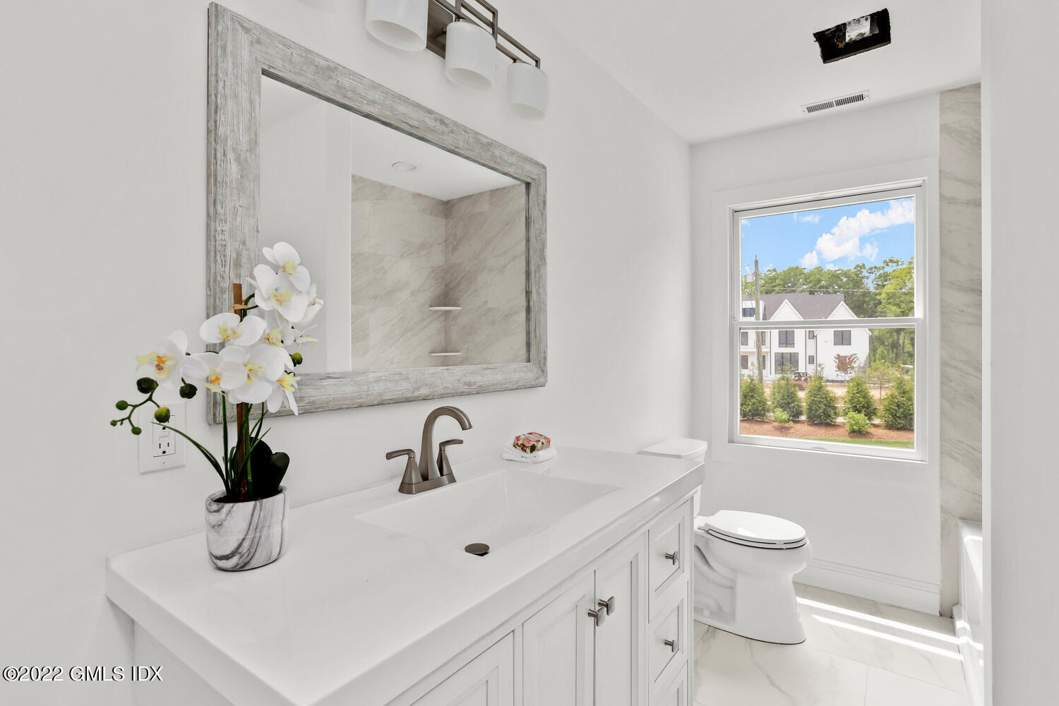 433 Stanwich Road Greenwich, CT 06830 - Photo 23 of 37 a bathroom with a sink a toilet and a mirror