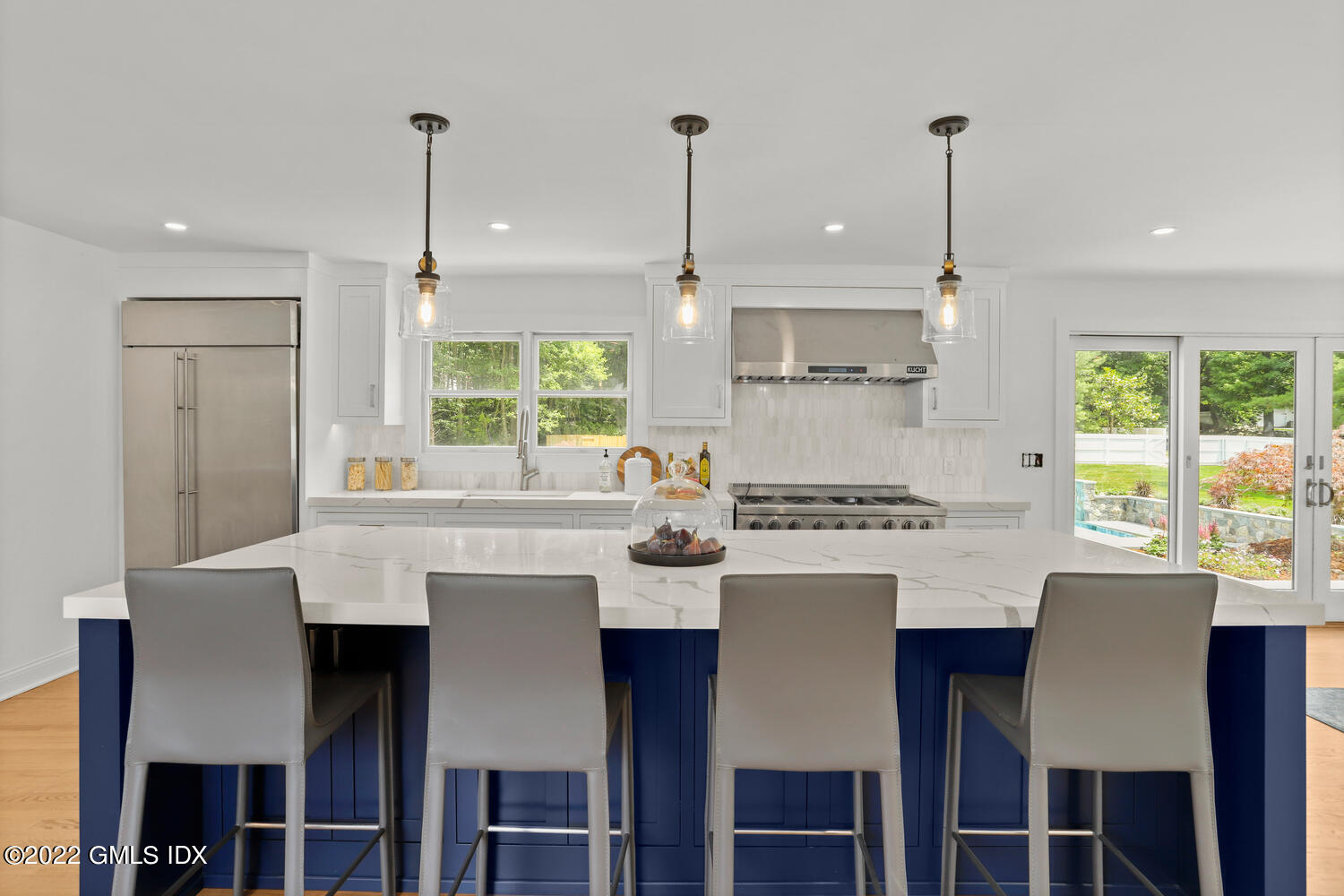 433 Stanwich Road Greenwich, CT 06830 - Photo 5 of 37 a kitchen with a dining table chairs refrigerator and cabinets
