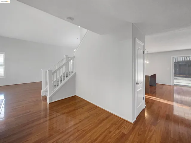 a view of an empty room and wooden floor