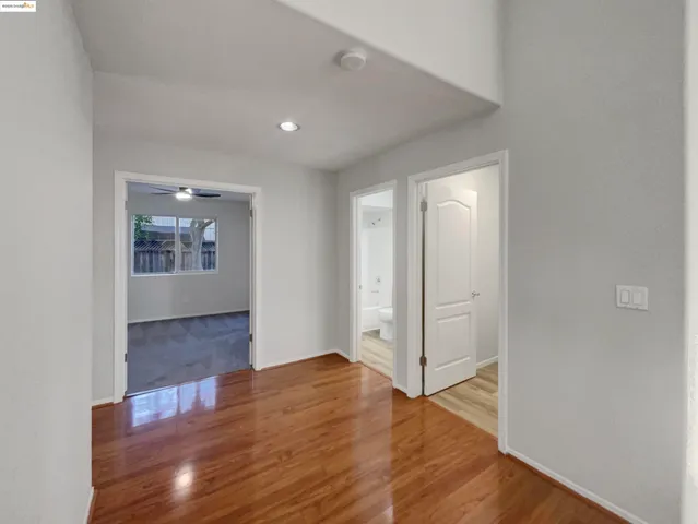 a bathroom with a sink a toilet a mirror a vanity and bathtub