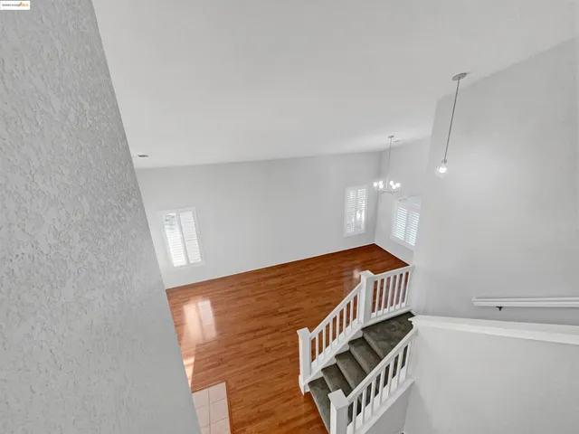 a hallway with white cabinets