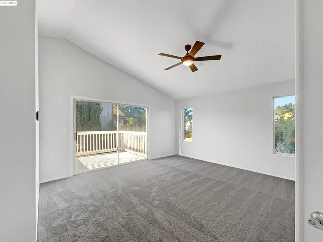 a view of empty room with ceiling fan