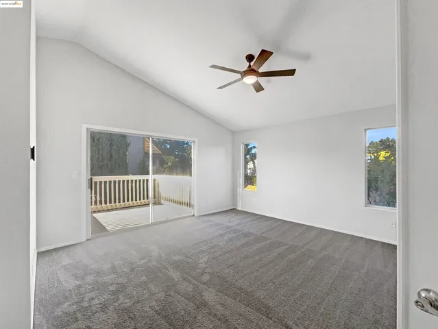 a view of a livingroom with a ceiling fan and window