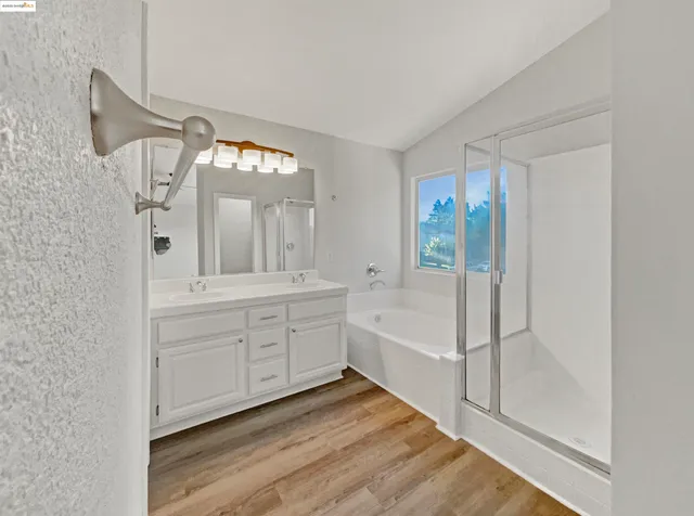 a bathroom with a tub sink and mirror
