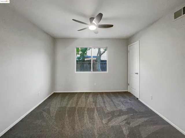 a large kitchen with stainless steel appliances granite countertop a stove a sink dishwasher and a oven with wooden floor