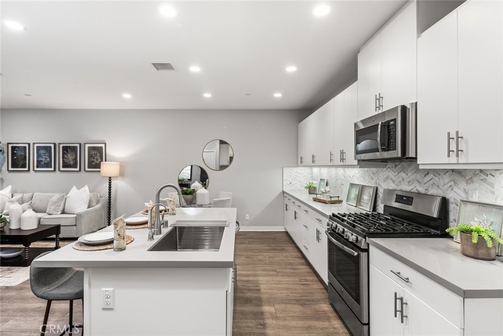 15 Jasmine Lake Forest, CA 92630 - Photo 11 of 44 a kitchen with counter top space cabinets and stainless steel appliances
