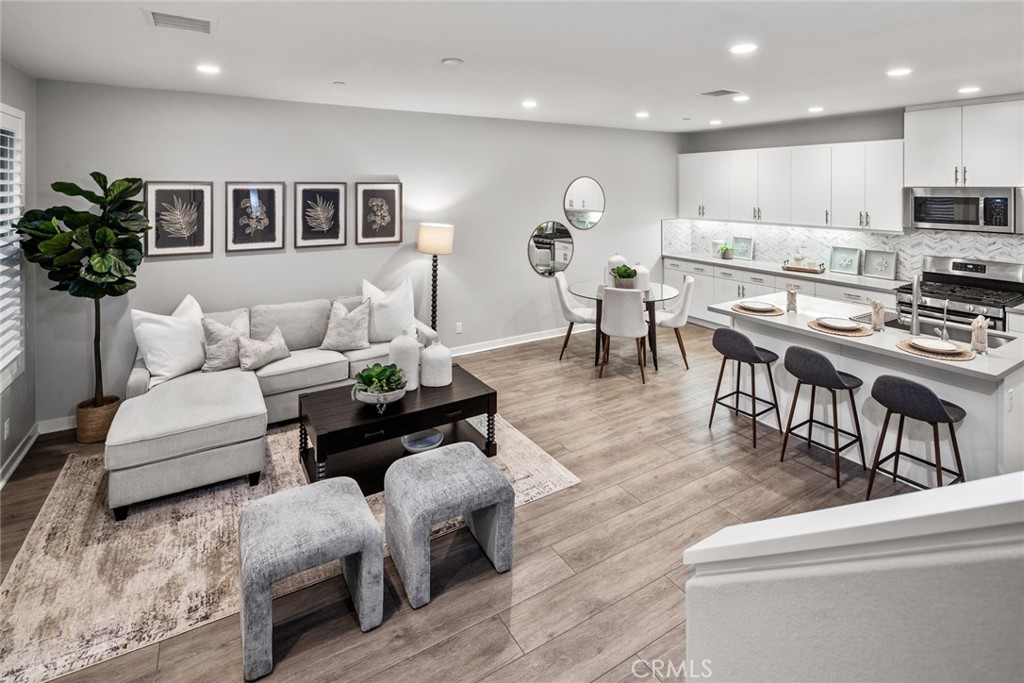 15 Jasmine Lake Forest, CA 92630 - Photo 16 of 44 a living room with couches and kitchen view with wooden floor