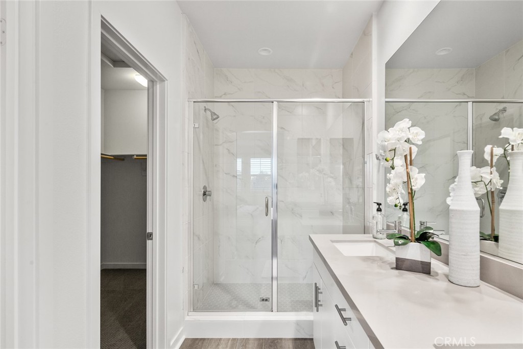 15 Jasmine Lake Forest, CA 92630 - Photo 22 of 44 a bathroom with a granite countertop shower a mirror and a sink