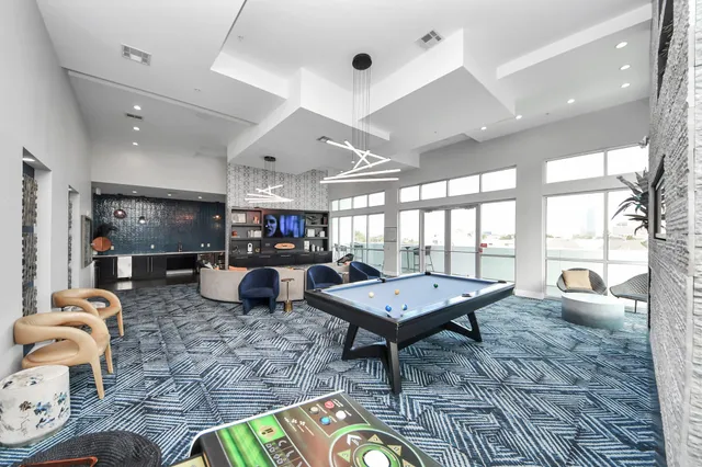 a kitchen with stainless steel appliances a refrigerator a sink a stove and white cabinets