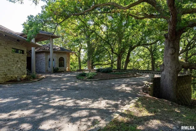 a view of a dining room with furniture a chandelier and a window