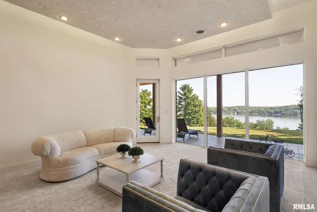 a view of a dining room with furniture large windows and wooden floor