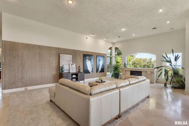 a living room with furniture and a floor to ceiling window