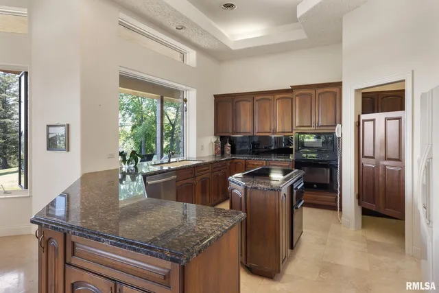 a kitchen with stainless steel appliances granite countertop a sink and cabinets