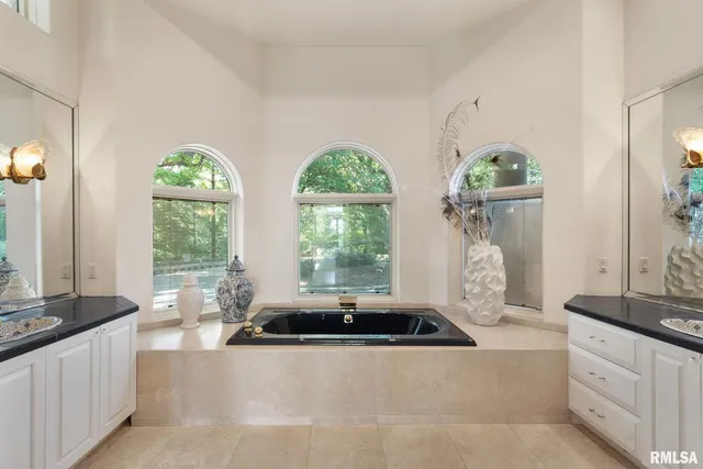 an aerial view of a residential houses with outdoor space and lake view