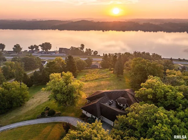 a view of a grey house with a yard