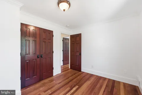a view of a room with wooden floor and stairs