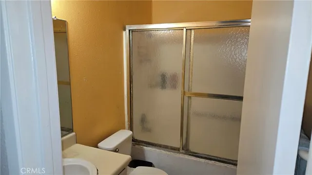 a kitchen with kitchen island granite countertop a sink cabinets and stainless steel appliances