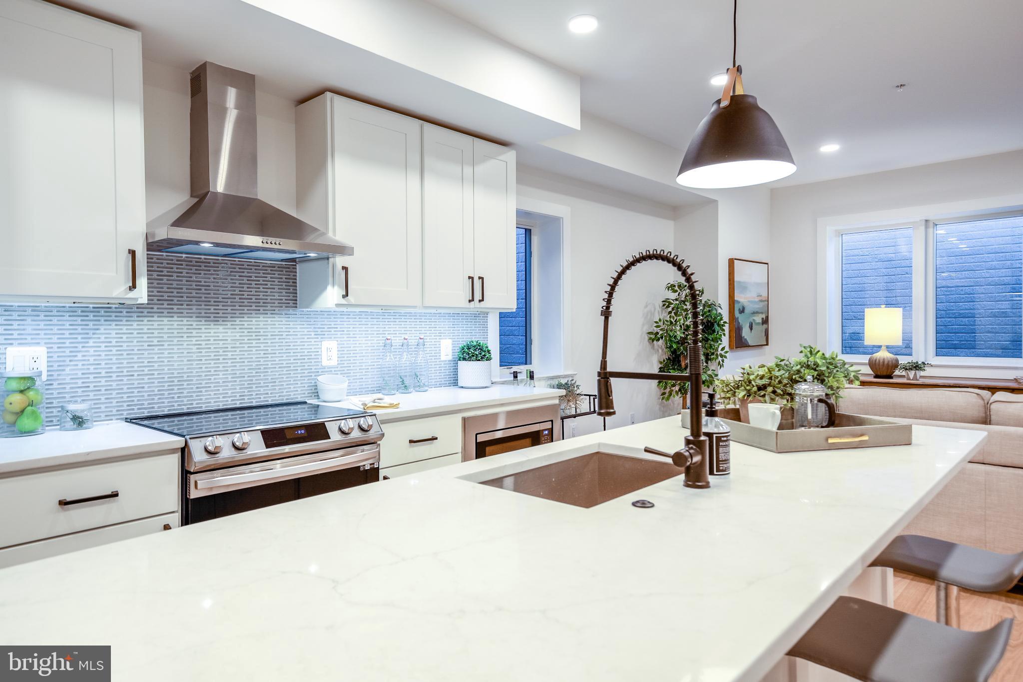 1009 Rhode Island Avenue Northeast, Unit 1 Washington, DC 20018 - Photo 11 of 21 a kitchen with stainless steel appliances a sink a stove and cabinets