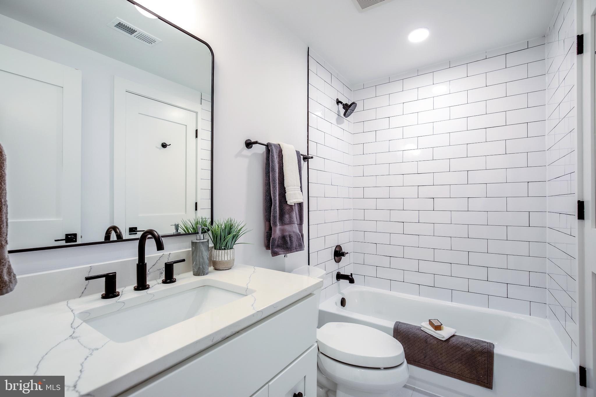 1009 Rhode Island Avenue Northeast, Unit 1 Washington, DC 20018 - Photo 15 of 21 a bathroom with a sink a toilet and shower