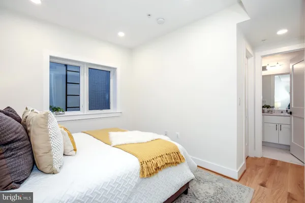 a bedroom with a bed and a view of kitchen