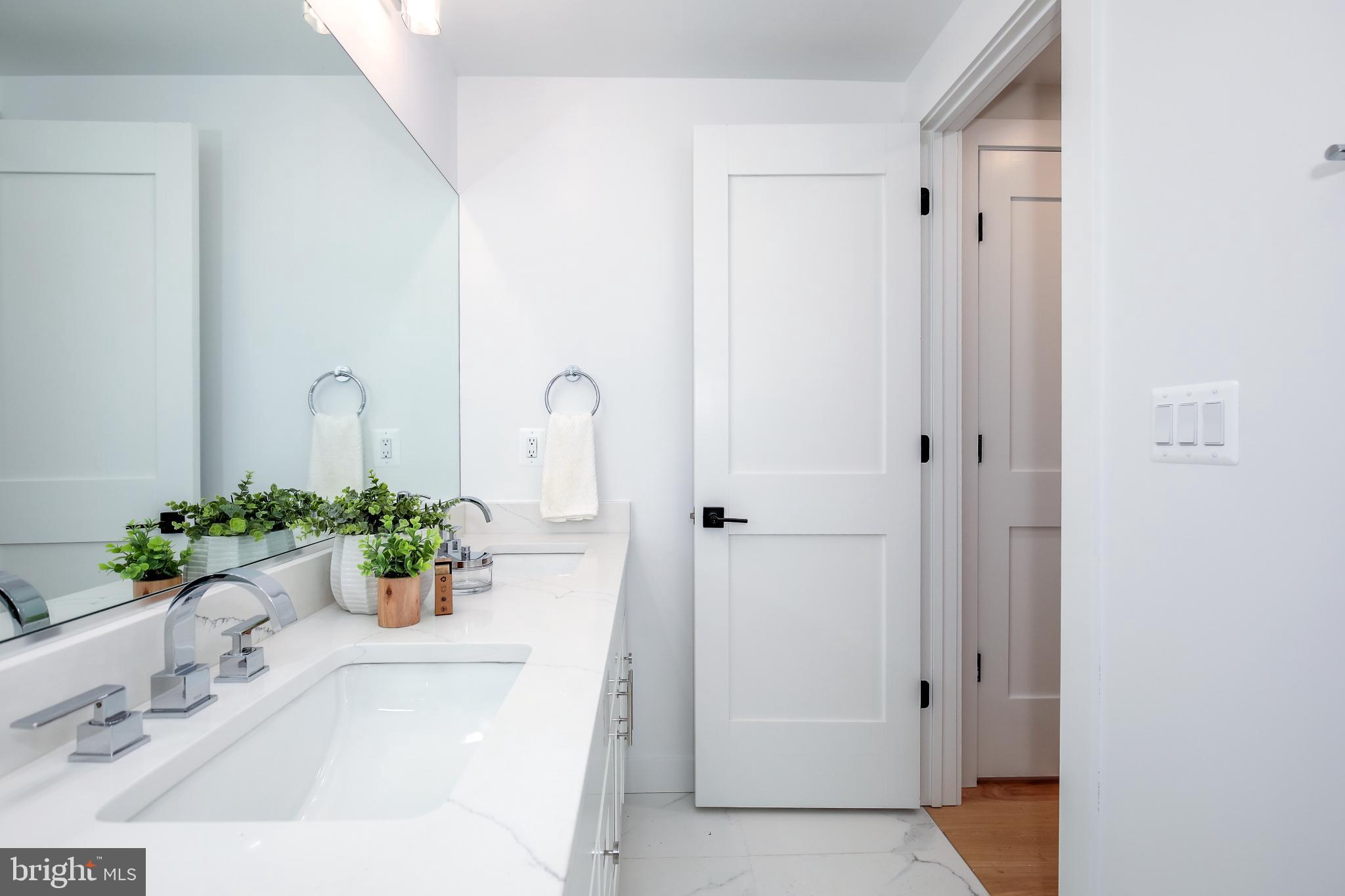 1009 Rhode Island Avenue Northeast, Unit 1 Washington, DC 20018 - Photo 20 of 21 a white bath tub sitting in a bathroom