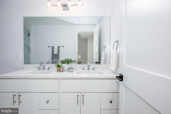 a bathroom with a sink vanity and a mirror