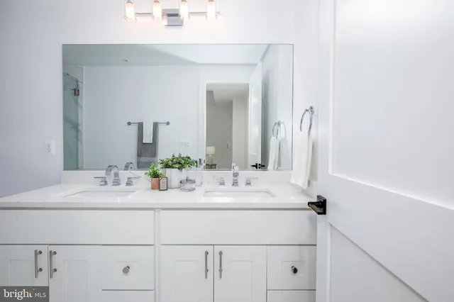 a bathroom with a sink vanity and a mirror