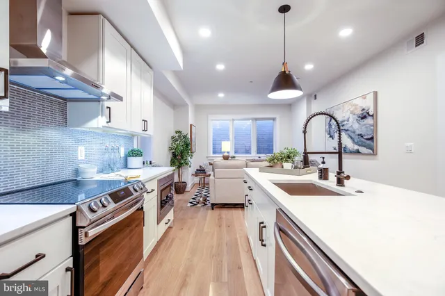 a kitchen with a sink stove and cabinets
