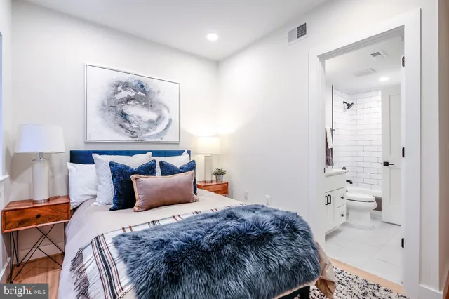 a bedroom with a bed and a painting on the wall