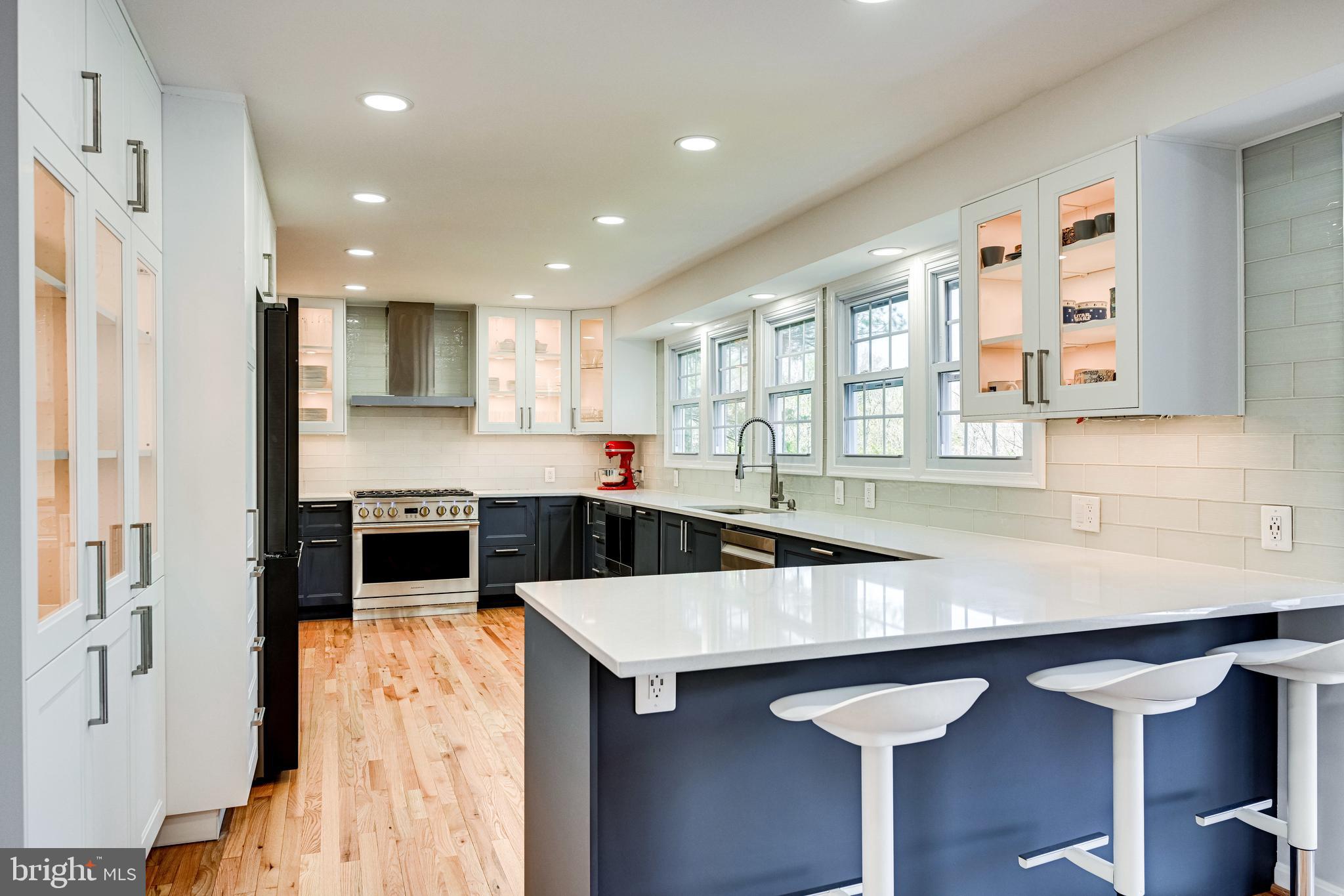 a kitchen with stainless steel appliances a sink and cabinets