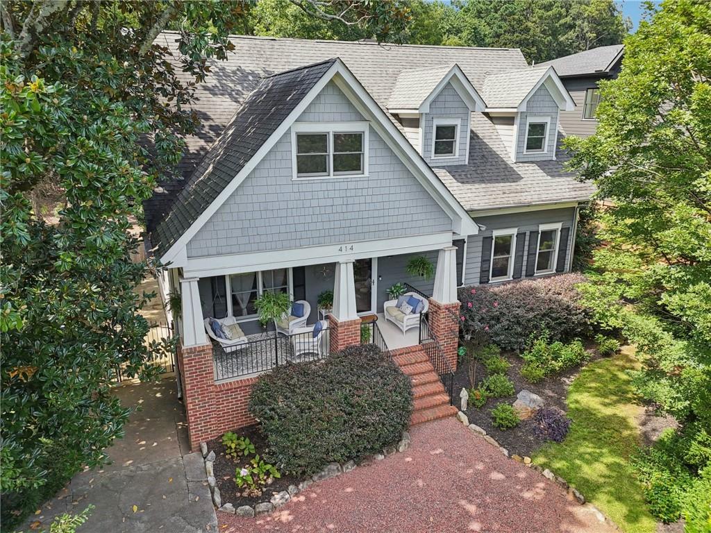 a front view of house with yard and trees around