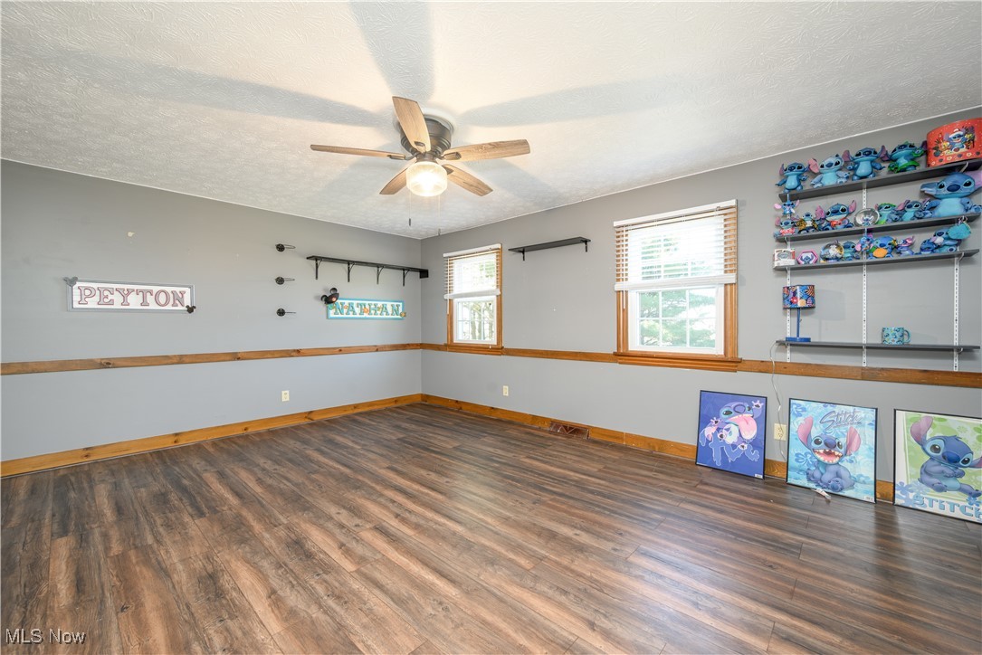 2061 Portage Line Road Mogadore, OH 44260 - Photo 36 of 48 Spare room featuring ceiling fan, baseboards, a textured ceiling, and wood finished floors