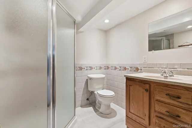 a bathroom with a sink a toilet and vanity