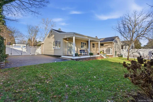 a front view of a house with a yard and trees