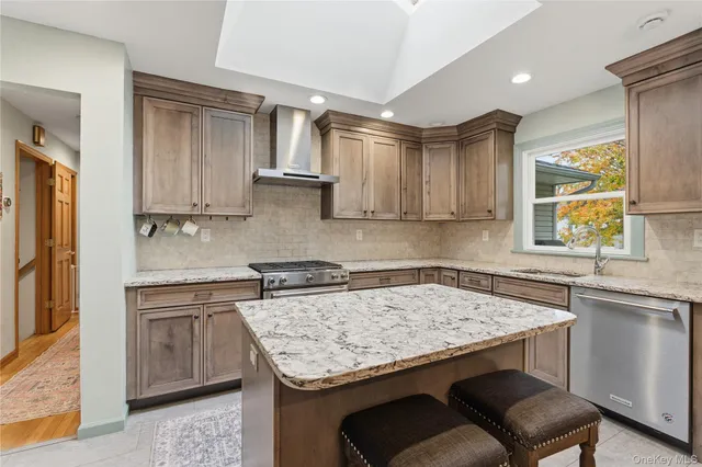 a kitchen with a stove sink and cabinets