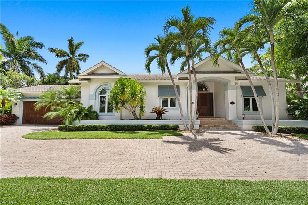 2201 Beacon Lane Naples, FL 34103 - Photo 2 of 25 a front view of a house with garden