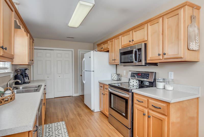 2242 Dewey Drive Spring Hill, TN 37174 - Photo 11 of 29 a kitchen with stainless steel appliances granite countertop a stove a sink dishwasher and a microwave oven with cabinets